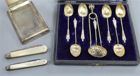 A silver mounted desk clip, two mother of pearl fruit knives including Victorian, a cased set of silver spoons with tongs etc.